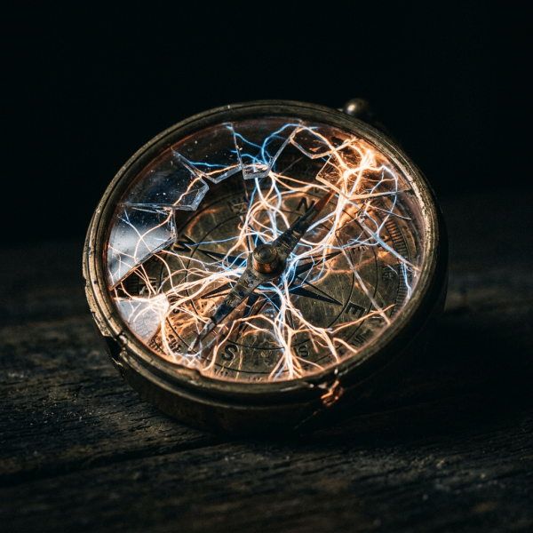 Vintage compass with broken glass and glowing electric light strands